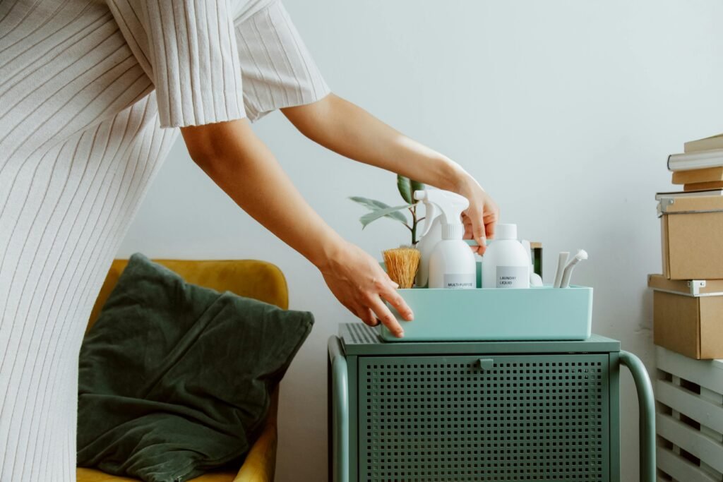 A woman organizes self-care products in a stylish room, embodying minimalism and tranquility.